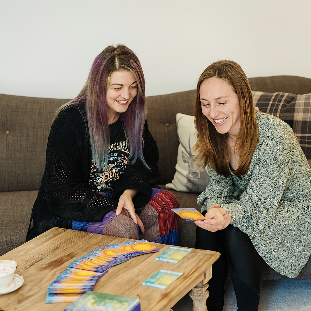 Lucy teaching a lady how to use the cards